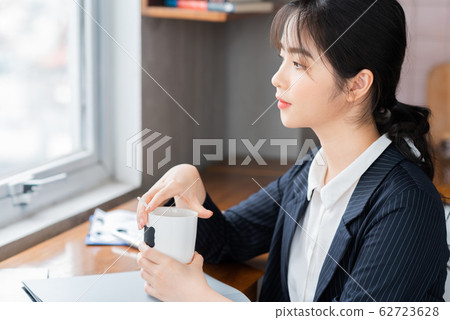 A business woman reading the document in the office 62723628