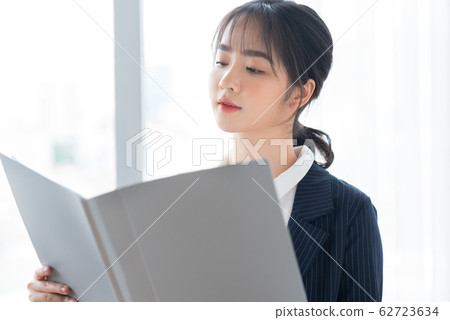 A business woman beside the window 62723634