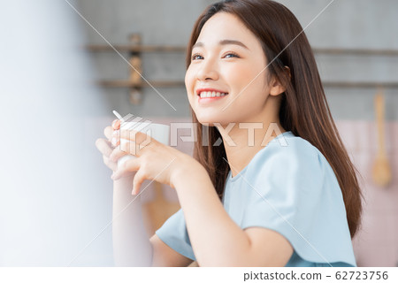 A beauty woman drink coffee by the window in the morning 62723756