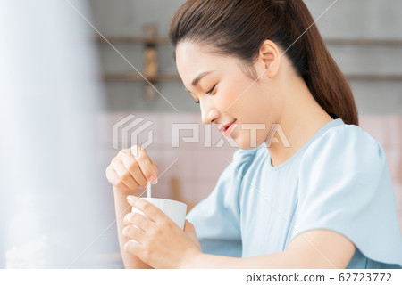 A beauty woman drink coffee by the window  62723772