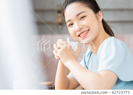 A beauty woman drink coffee by the window A beauty woman drink coffee by the window 62723773