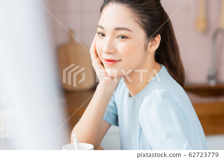 A beauty woman drink coffee by the window 62723779