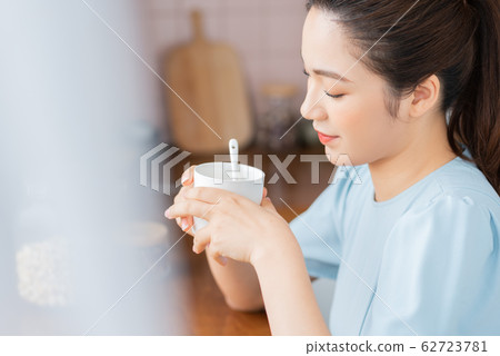 A beauty woman drink coffee by the window 62723781