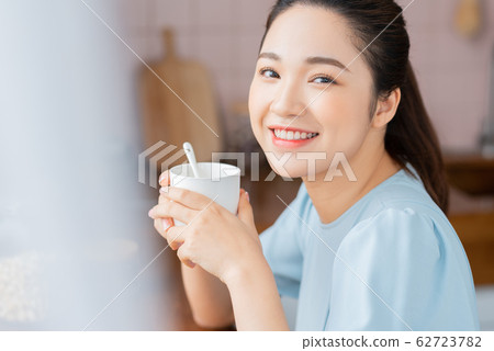A beauty woman drink coffee by the window 62723782