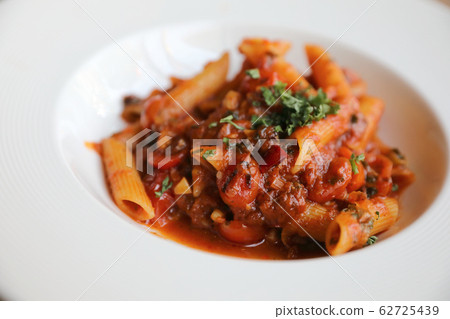 Penne arrabiata pasta tomato sauce with spices italian food on wood background 62725439