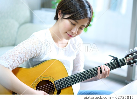 Woman with acoustic guitar Woman with acoustic guitar 62725815