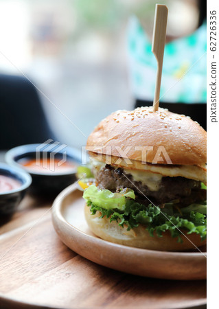 Beef hamburger with cheese green salad egg and sauce in restaurant Beef hamburger with cheese green salad egg and sauce in restaurant 62726336