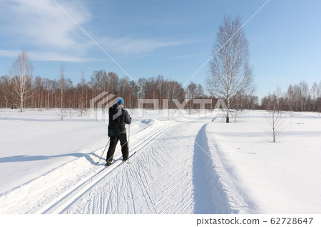 Man with a backpack skiing on a ski track 62728647