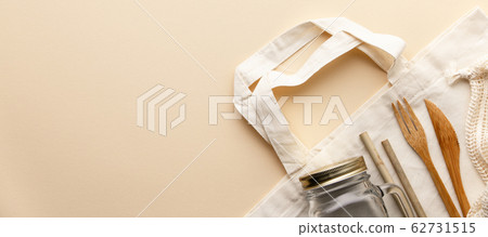 Cotton bag, bamboo cultery, glass jar, bamboo toothbrushes, hairbrush and straws on color background, flat lay. 62731515