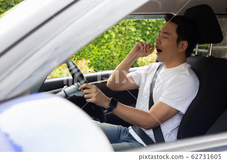 Tired young man sleep in car, Hard work causes Tired young man sleep in car, Hard work causes 62731605