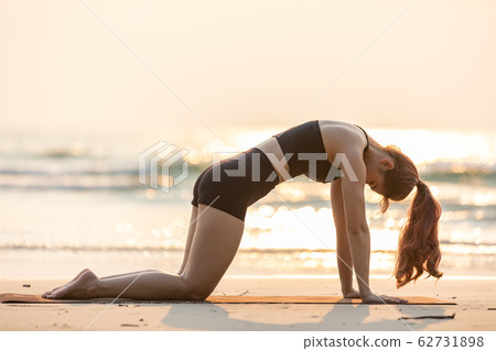 Vacations of Asian young woman practice Yoga on the beach in thailand Vacations of Asian young woman practice Yoga on the beach in thailand 62731898