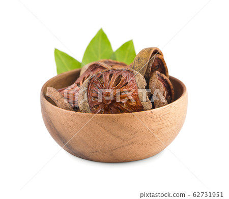 dried quince slices in wooden bowl an isolated on 62731951