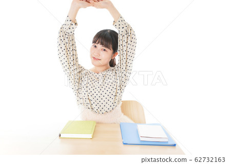 Young woman studying at desk Young woman studying at desk 62732163