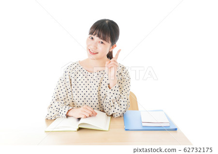 Young woman studying at desk Young woman studying at desk 62732175