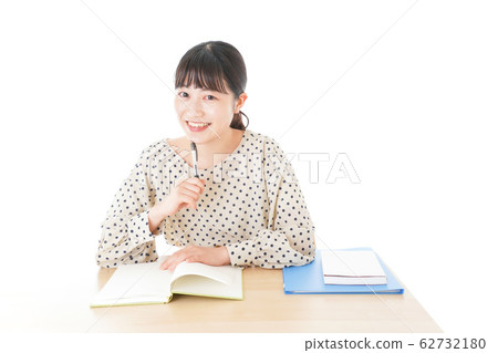 Young woman studying at desk Young woman studying at desk 62732180