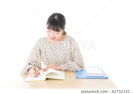 Young woman studying at desk Young woman studying at desk 62732181
