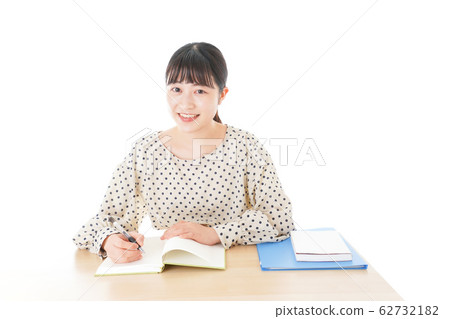 Young woman studying at desk Young woman studying at desk 62732182