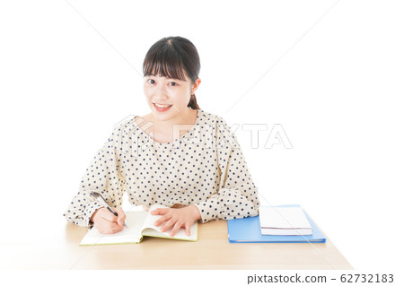 Young woman studying at desk Young woman studying at desk 62732183
