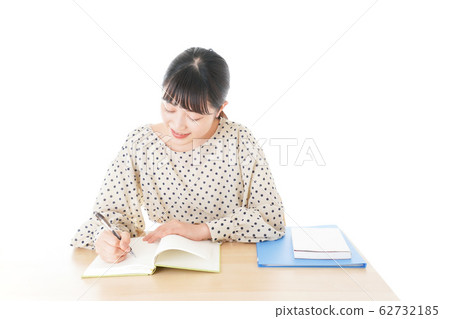 Young woman studying at desk Young woman studying at desk 62732185