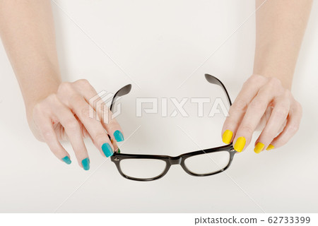 Woman hands with black glasses Woman hands with black glasses 62733399