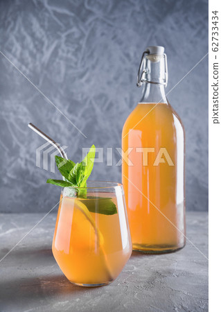 Kombucha healthy tasty drink in bottle and glass Kombucha healthy tasty drink in bottle and glass 62733434