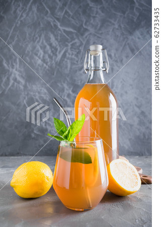 Kombucha healthy tasty drink in bottle and glass Kombucha healthy tasty drink in bottle and glass 62733435