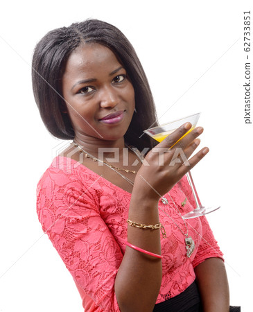 Beautiful African woman drinking orange juice Beautiful African woman drinking orange juice 62733851