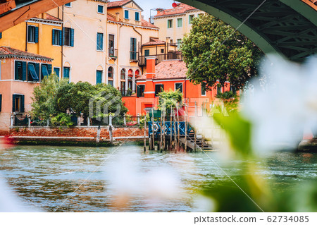 Old ancient facades of houses on Grand Canal, Venice, Italy. Vintage historical architecture buildings of Venice on water in summer season Old ancient facades of houses on Grand Canal, Venice, Italy. Vintage historical architecture buildings of Venice on water in summer season 62734085