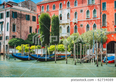 Old ancient vivid colored facades of houses on Grand Canal, Venice, Italy. Vintage hotels and residential buildings in historical architecture of Venice on water on summer vacation 62734089