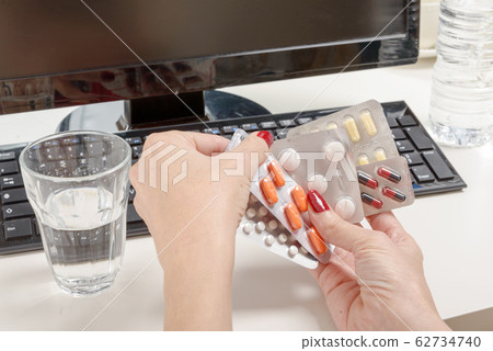 Pills with a computer, work pressure concept. 62734740