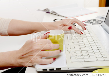 close up of hand of woman with cup of coffee on 62734745