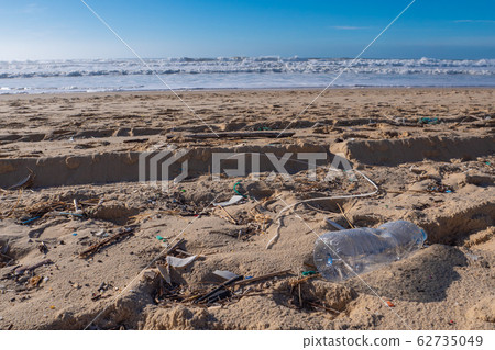 Plastic bottle on the beach, pollution 62735049