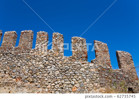 Fragment of the fortress wall with battlements. 62735745