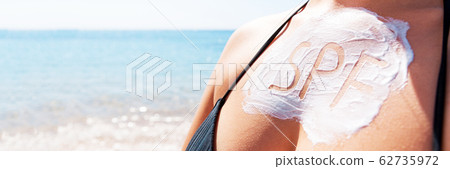 Word spf made of sunscreen lotion on woman's Word spf made of sunscreen lotion on woman's 62735972