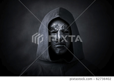 Scary figure in hooded cloak with mask Scary figure in hooded cloak with mask 62736402