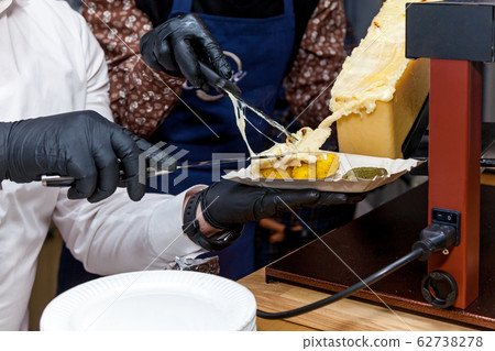 A chef is cooking raclette 62738278