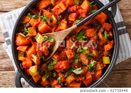 Tasty spicy sweet potatoes and black beans with 62738446