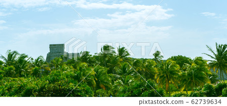 Ruins of ancient Tulum. Architecture of ancient maya. View with temple and other old buildings, houses. Blue sky and lush greenery of nature. travel photo. Wallpaper or background. Yucatan. Ruins of ancient Tulum. Architecture of ancient maya. View with temple and other old buildings, houses. Blue sky and lush greenery of nature. travel photo. Wallpaper or background. Yucatan. 62739634