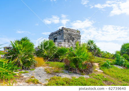 Ruins of ancient Tulum. Architecture of ancient maya. View with temple and other old buildings, houses. Blue sky and lush greenery of nature. travel photo. Wallpaper or background. Yucatan.  62739640