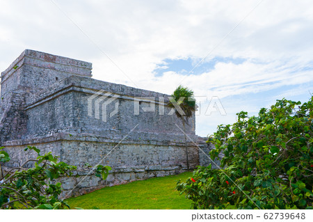 Ruins of ancient Tulum. Architecture of ancient maya. View with temple and other old buildings, houses. Blue sky and lush greenery of nature. travel photo. Wallpaper or background. Yucatan.  62739648