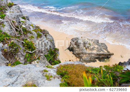 Caribbean coast near Tulum. Turquoise sea and blue sky. Nature with rocks and plants. Travel photo, background. Yucatan. Quintana roo. Caribbean coast near Tulum. Turquoise sea and blue sky. Nature with rocks and plants. Travel photo, background. Yucatan. Quintana roo. 62739660