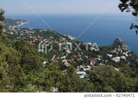 a quiet coastal town under a blue sky on the backg 62740471