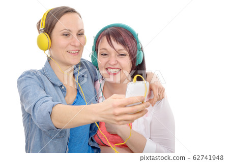 Two young hispanic women taking a selfie. Two young hispanic women taking a selfie. 62741948