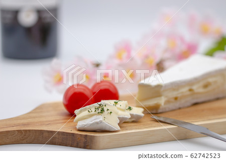 Brie cheese and cutting board red wine 62742523