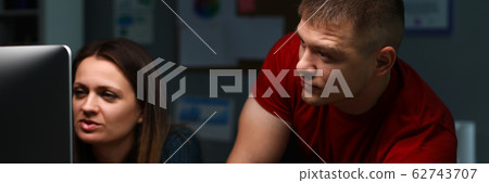 Man and girl are sitting work and looking monitor 62743707