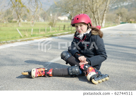 young attractive teenage skater grimacing in pain 62744511