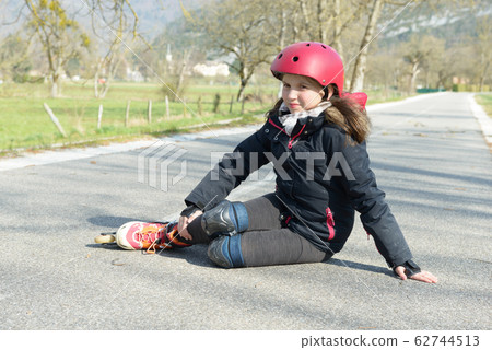 Young attractive teenage skater grimacing in pain 62744513