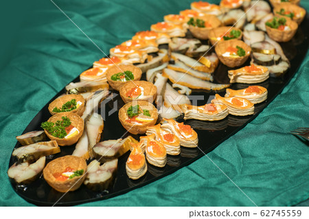 Tartlets with red caviar close up. Gourmet food close up, appetizer 62745559