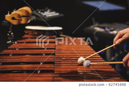 A man playing a marimba on a concert stage A man playing a marimba on a concert stage 62745898