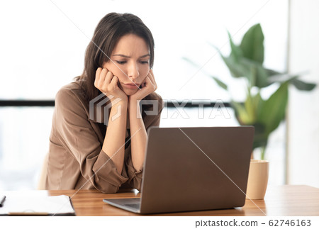 European young student using pc at work place 62746163